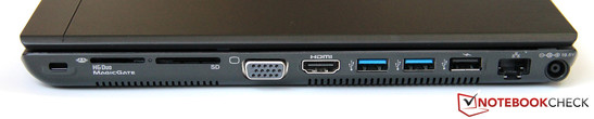 Direita: Seguro Kensington, dois leitores de cartões, VGA, HDMI, 2x USB 3.0, USB 2.0, GBit LAN, Conector de força