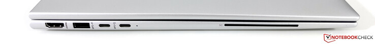 Esquerda: HDMI 2.0b, USB-A 3.2 Gen.1 (5 GBit/s) 2x USB-C 4.0 (40 GBit/s, modo DisplayPort ALT 1.4, Alimentação), leitor SmartCard (opcional)