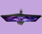 A imagem mostra o monitor para jogos AOC AG276UZ contra um fundo roxo. O monitor para jogos apresenta um design bem voltado para jogos, com iluminação RGB na parte traseira.