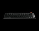 O teclado é usinado por CNC a partir de um único bloco de alumínio e inclui um seletor giratório magnético removível para controle de volume e mídia.