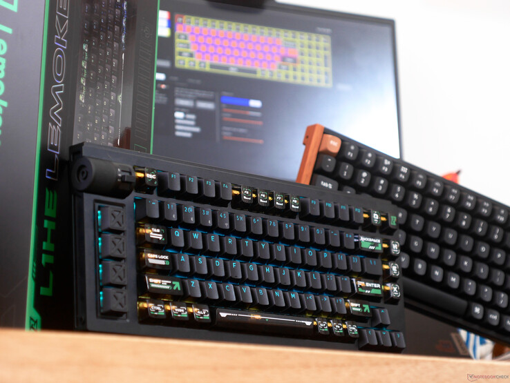 Teclas brilhantes do teclado Lemokey L1 HE em uma mesa em frente a um laptop e do teclado K4 HE