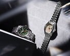 O Seiko 5 Sports Field GMT HDB001, com mostrador verde, e o HDB002, com mostrador creme, exibidos lado a lado em pulseiras de aço inoxidável de cinco elos, cada um com uma luneta fixa de 24 horas e um ponteiro GMT laranja.