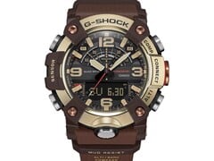 Close-up do G-Shock Mudmaster GG-B100XMH-5A, destacando sua caixa e luneta nas cores amarelo-ouro claro e marrom.