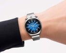 Um Citizen Tsuno Chronograph com mostrador azul em degradê e pulseira de aço inoxidável, usado no pulso contra um fundo branco.