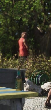 Um homem parece estar urinando contra uma árvore (captura de tela ampliada do GTA 6).