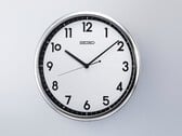 Relógio de parede de quartzo retro Seiko KX701S com moldura prateada e mostrador em preto e branco contrastantes.