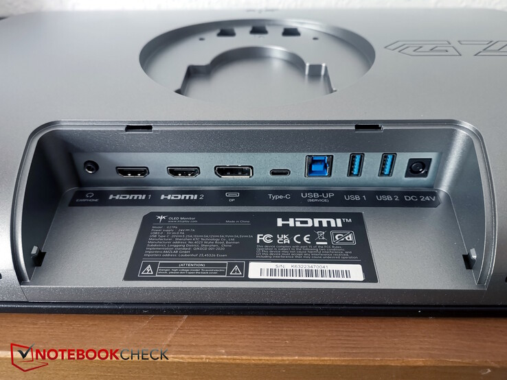 Da esquerda para a direita: Fones de ouvido, 2x HDMI, DP, USB-C, USB-B para cima, 2x USB-A, alimentação
