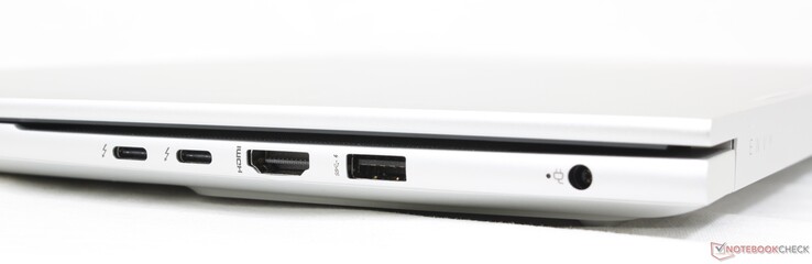 Direita: 2x USB-C c/ Thunderbolt 4 + DisplayPort 1.4, HDMI 2.1, USB-A 10 Gbps, adaptador AC